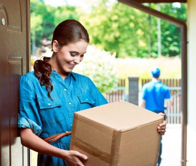 A woman is presenting a box, with a man standing behind her, highlighting Loxxie Hair's brand.
